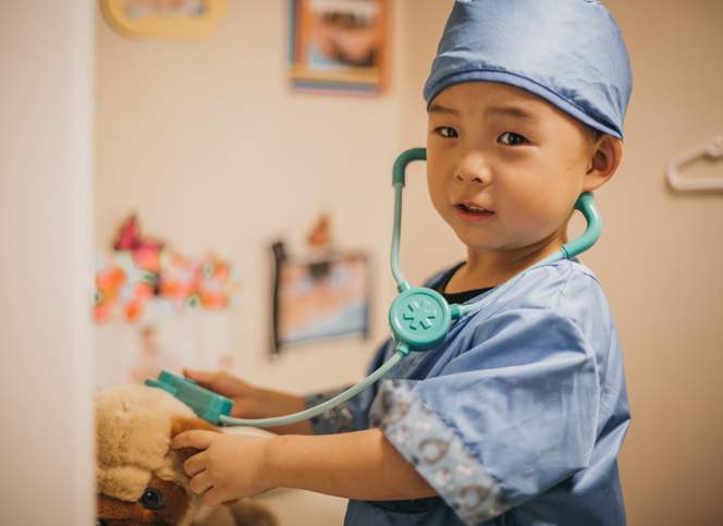 child dressed up as a doctor in kindergarten room first five