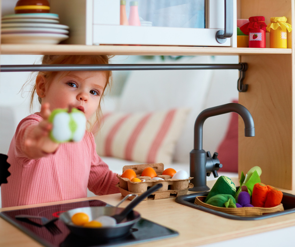 toddler playing in home corner